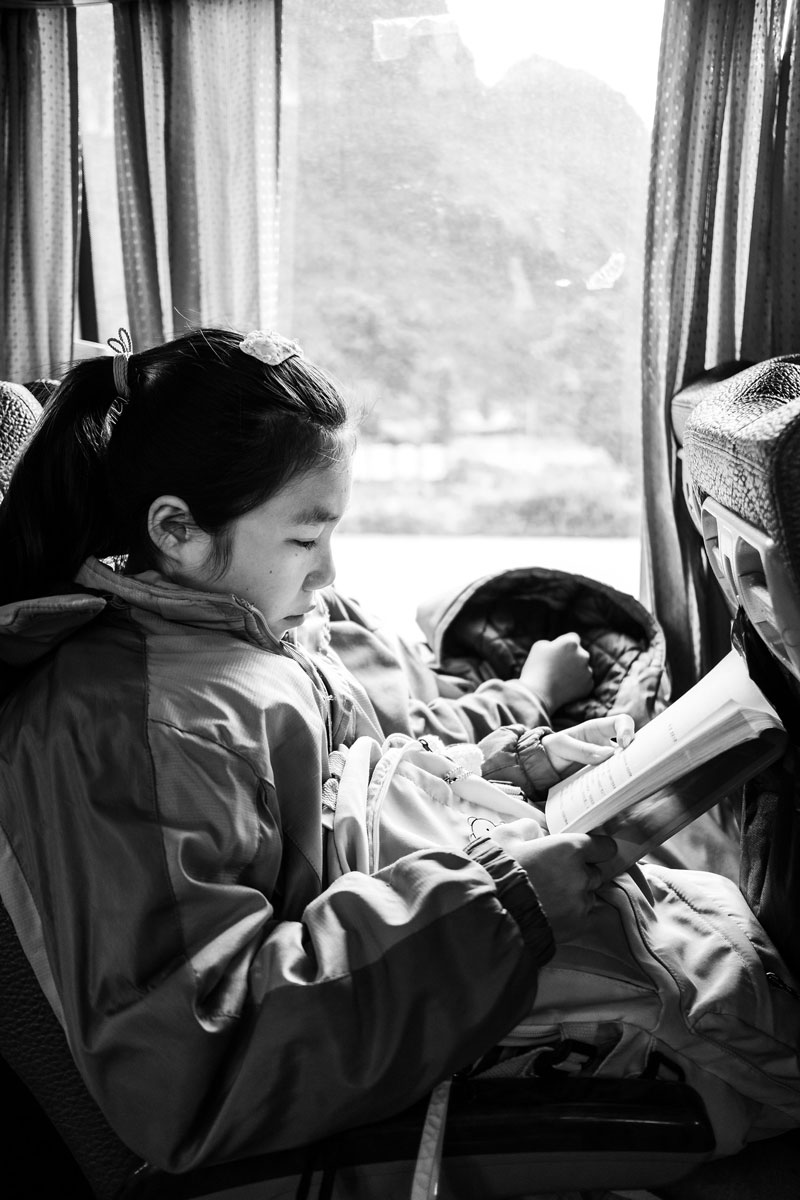 girl reading on bus