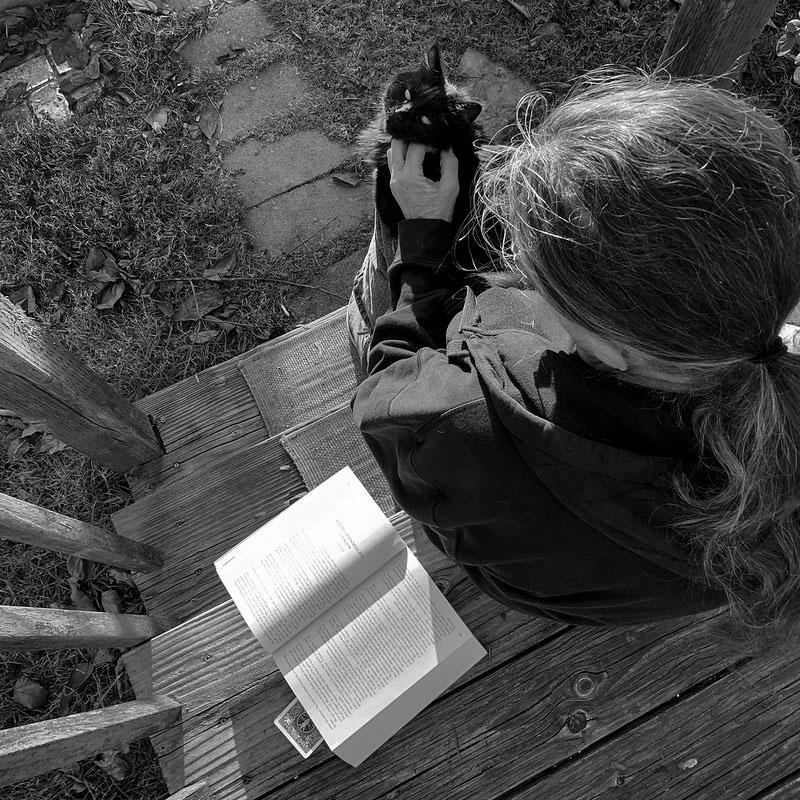 woman with cat and book