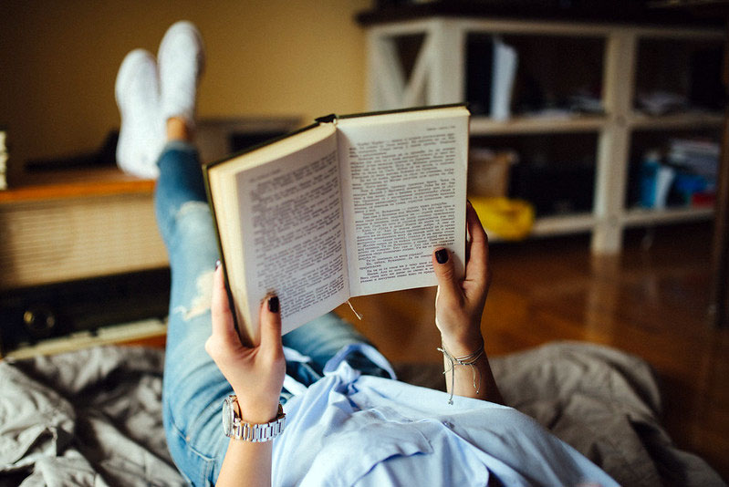 reading book with legs propped up