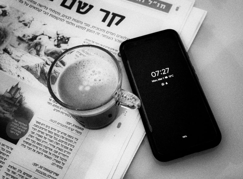 newspaper, coffee and phone